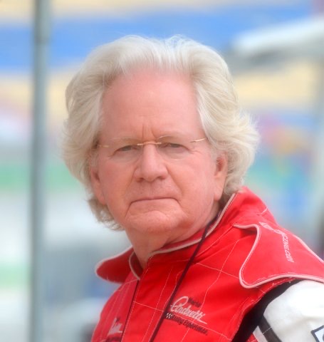 Bruce Paul, a white-haired man in glasses and a red racing jacket